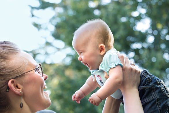 Woman holding laughing baby